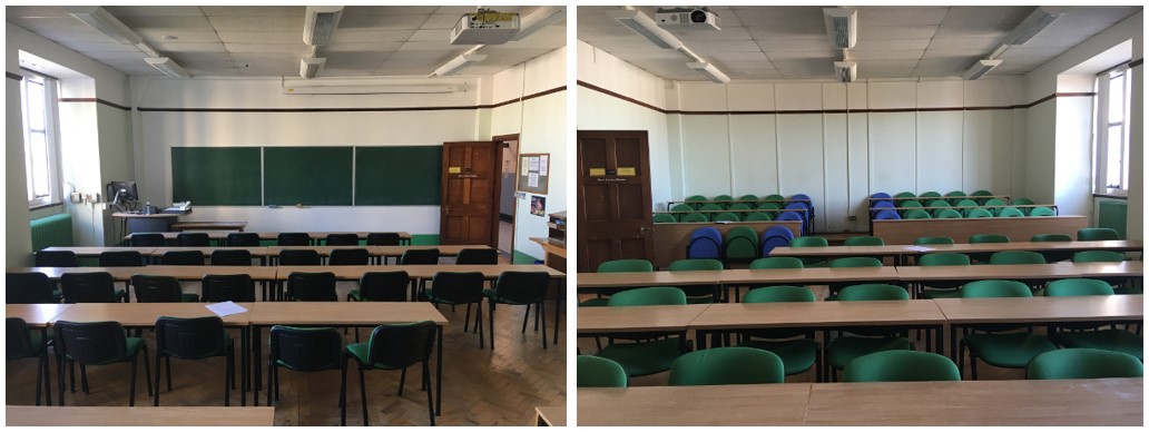 Classroom with rows of tables and chairs plus tiered seating at back of room.